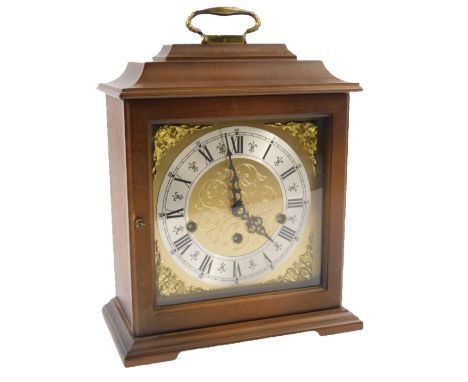 A modern German mantel clock, in a mahogany case with Westminster chime on bracket feet, 25cm W.
