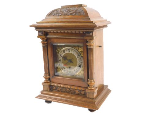 A German walnut cased mantel clock, carved in Art Nouveau style with reeded columns, Westminster chime, 45cm H.