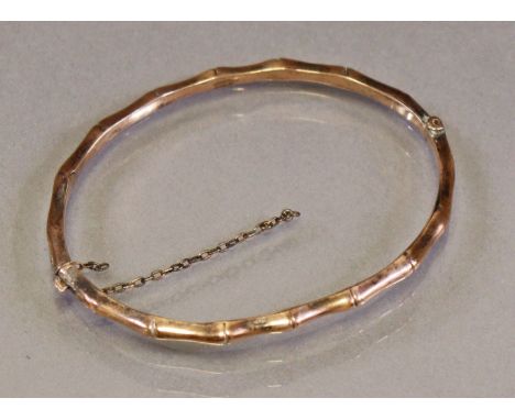 A late Victorian 9ct gold narrow stiff hinged bangle of bamboo design (4.5g).