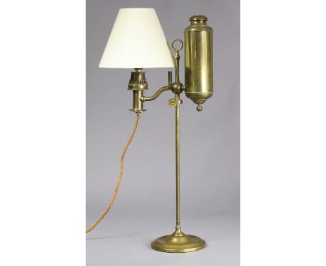 An Edwardian brass oil table lamp (converted to electricity) on adjustable column with circular base, 60cm high.