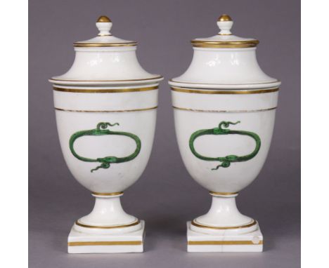 A pair of late 18th/early 19th century continental porcelain ovoid vases &amp; covers, each painted in green enamel with two 