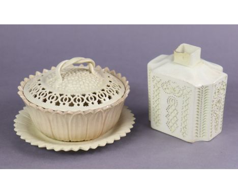 An 18th century English creamware cruciform tea caddy with reticulated decoration, the underside with incised initials J. C.,
