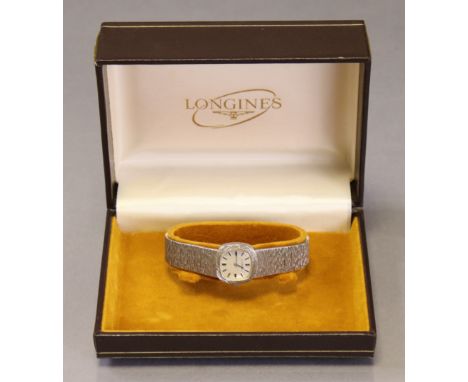 A Longines silver ladies’ bracelet watch, the silvered cushion-shaped engine turned dial with baton numerals, the bracelet wi