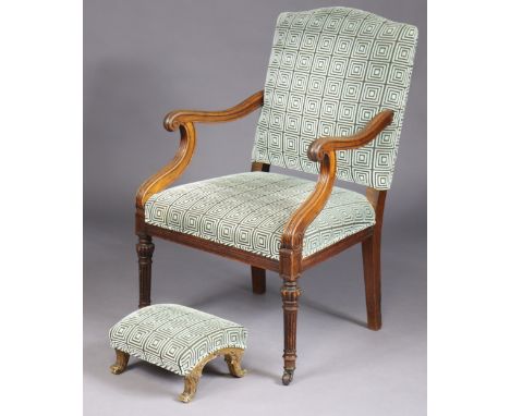 A William IV mahogany elbow chair with padded back and seat, open scroll arms with reeded supports, on turned fluted legs wit