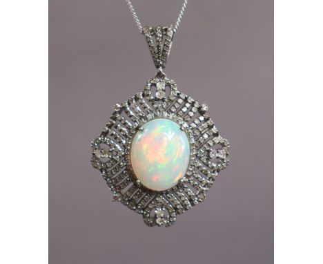 AN OPAL PENDANT, the large oval cabochon opal weighing approx. 5.2 carats, set within a wide open-work border of numerous sma