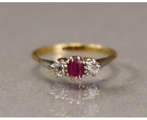 An 18ct gold &amp; platinum ring set small rectangular-cut ruby between two round-cut diamonds, size O (2.3g).