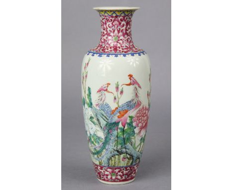 A Chinese famille rose porcelain slender ovoid vase painted with two Phoenix amongst peonies &amp; chrysanthemum with ruby-gr