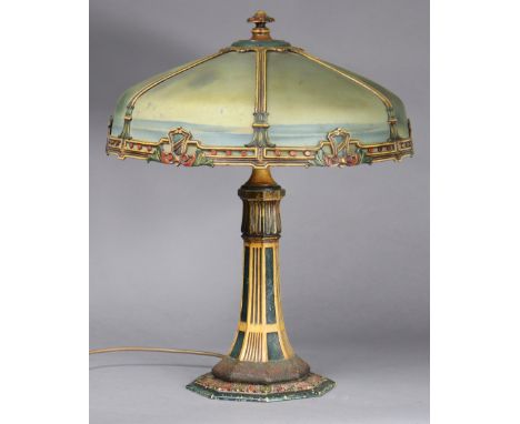 An art nouveau painted-metal & semi-opaque glass table lamp, the hexagonal shade with reverse-laid landscape decoration, on f