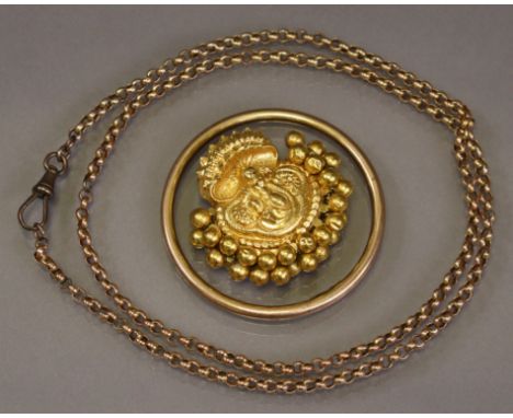 An Indian yellow metal covered mount with enshrined deity to the centre, partly encircled by a border of articulated small sp