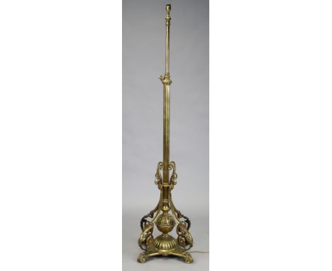 A Victorian brass standard lamp with adjustable column, foliate scrolling supports and quatre-form base with pierced feet, 14