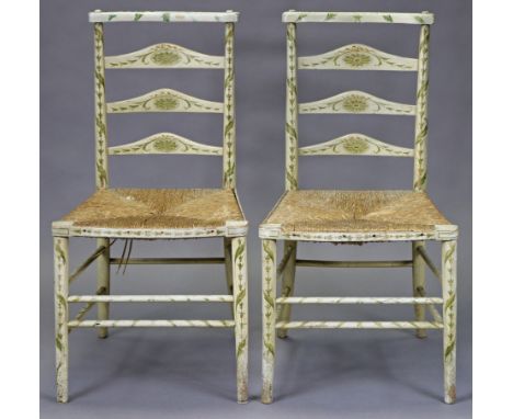 A pair of late 19th century cream-painted ladder-back occasional chairs with ribbon and husk-swag decoration, rush seats and 