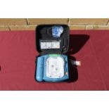 A Philips HeartStart defibrillator in hard carry case. Will require servicing/ recommissioning prior