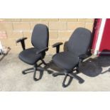 A pair of revolving adjustable office chairs with arm rests SUBJECT TO VAT