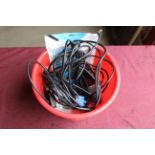 A bucket containing various cables to include, Ethernet, VGA, a hole punch, stapler, etc. SUBJECT TO