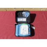 A Philips HeartStart defibrillator in hard carry case. Will require servicing/ recommissioning prior