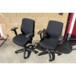 A pair of revolving adjustable office chairs with arm rests SUBJECT TO VAT