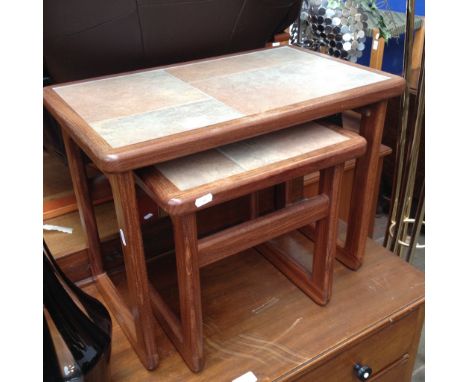 A TILE TOP NEST OF TWO TABLES