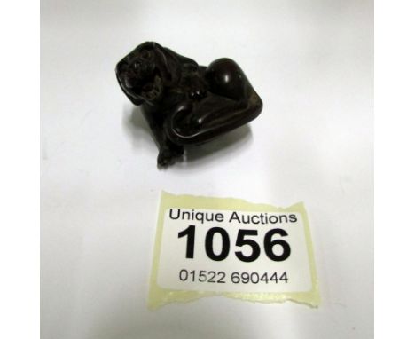 A carved wood netsuke