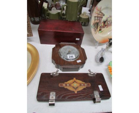 A mahogany box with brushes, barometer and tie press