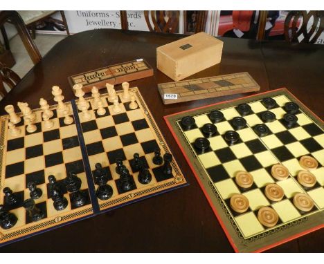 A chess set, draughts set and 2 cribbage boards
