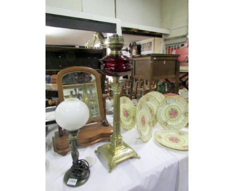 A Victorian Corinthian column brass oil lamp with ruby glass font