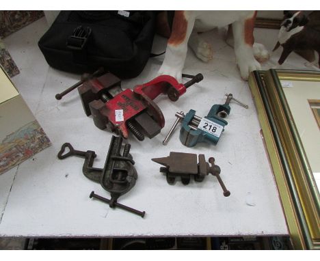 3 small bench vices and a miniature bench anvil