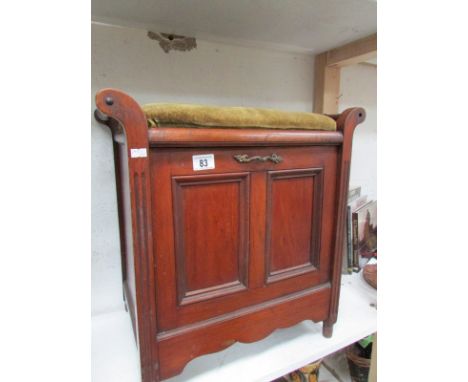 A piano stool with compartment for music