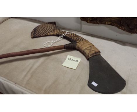 A Papua New Guinea double headed axe, one band with rush and one cut stone