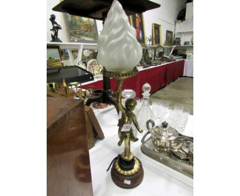 A gilded spelter cherub table lamp with glass flame shade