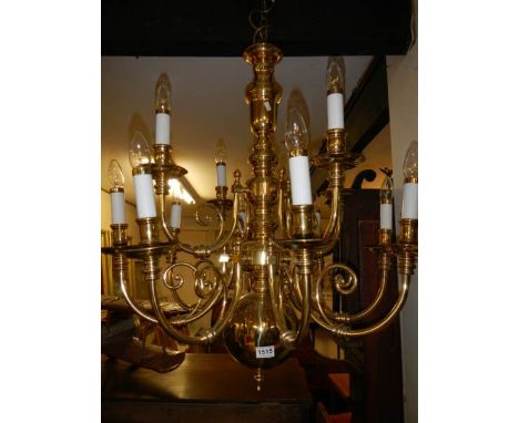 A heavy 12 lamp brass ceiling light