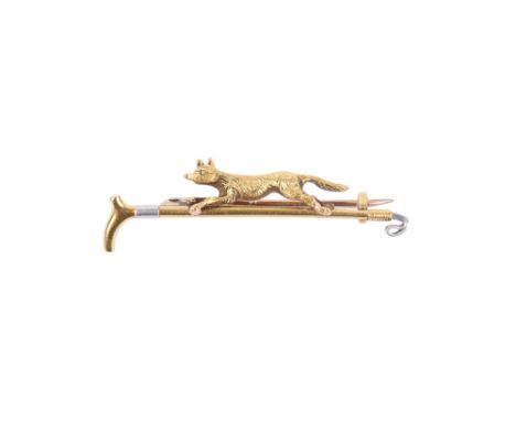 A yellow and white metal bar brooch with hunting motif, featuring a fox on the run over a riding crop. Overall length 48mm wi