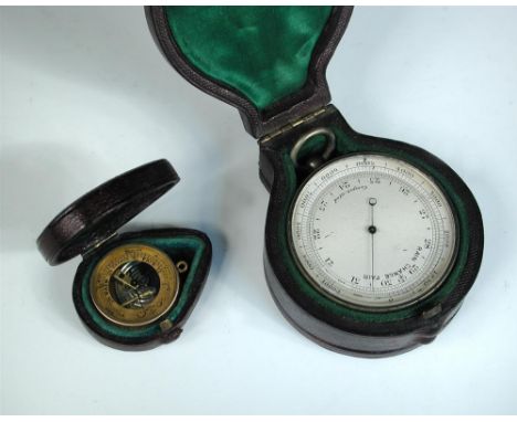 A circular pocket combination thermometer, compass and barometer, unsigned, housed in a fitted leather case 5cm (2in)  