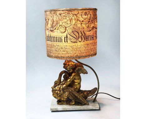 LAMP, gilded in the form of a cherub and swan on marble base, with parchment shade, 63cm H.