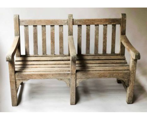 LISTER GARDEN BENCH, silvery weathered teak of substantial slatted construction incorporating centre arm rest, labelled Liste
