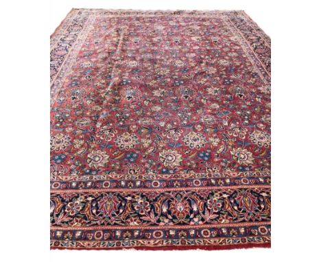 ANTIQUE KASHAN CARPET, 370cm x 260cm, all over design on a ruby field within corresponding borders.