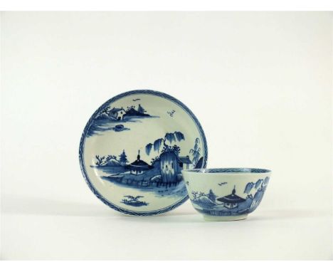 A Vauxhall porcelain tea bowl and saucer circa 1755-57, painted in underglaze blue with a Chinese inspired landscape of two d