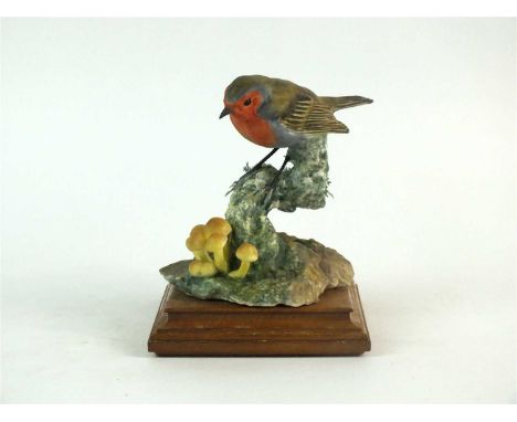 A Royal Worcester model of a Robin perched in Autumn Woods designed by Dorothy Doughty for the British Birds Series, factory 