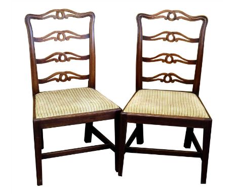Seven 19th century mahogany ladder back dining chairs, with pierced knotted scrolled backs above a fluted seat raised on tape