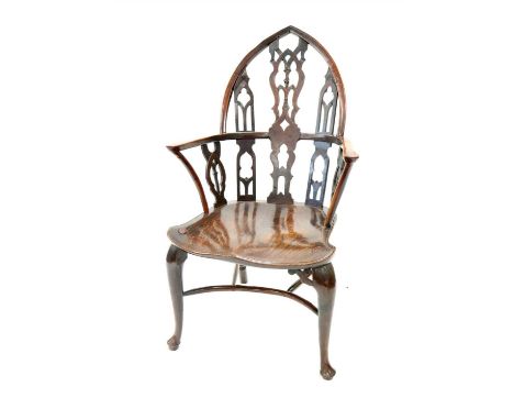 An unusual 18th century vernacular gothic Windsor armchair , the back and arms principally in yew wood, the central pierced s