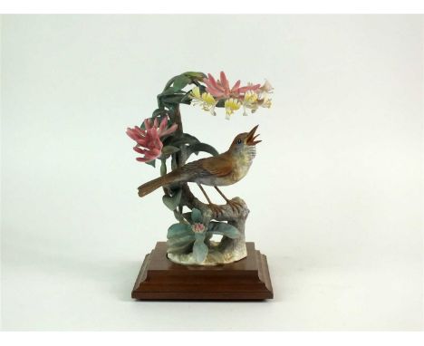 A Royal Worcester model of a Nightingale and Honeysuckle designed by Dorothy Doughty circa 1970, printed factory marks, with 