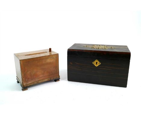 A Victorian coromandel veneered tea caddy, with an applied studded brass cartouche and lock escutcheon, opening to reveal a d