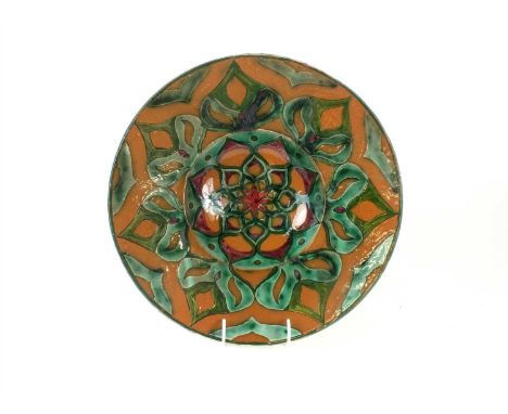 A Della Robbia Art Pottery charger by Lizzie Wilkins dated 1895, decorated in brown, green and red with stylised flowerhead m