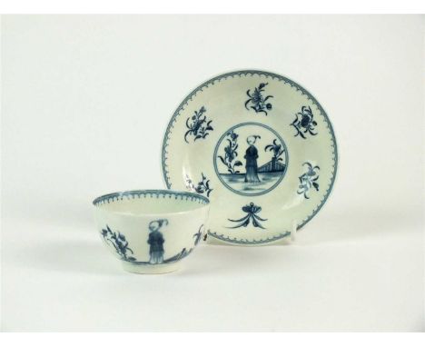 A Worcester porcelain tea bowl and saucer in the 'Waiting Chinaman' pattern circa 1770 painted in underglaze blue with the fi