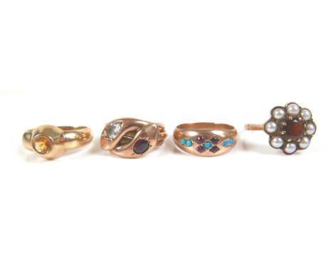 A group of four 9ct gold rings, including a ruby and turquoise set band, size N/O, a ring designed as two snake heads, set wi