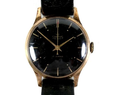 A vintage Smiths De Luxe gold plated gentleman's wristwatch, circa 1950's, circular black dial with gold batons, gold hand an