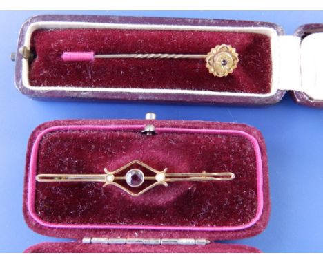 A gold stick pin and a bar brooch. (2)