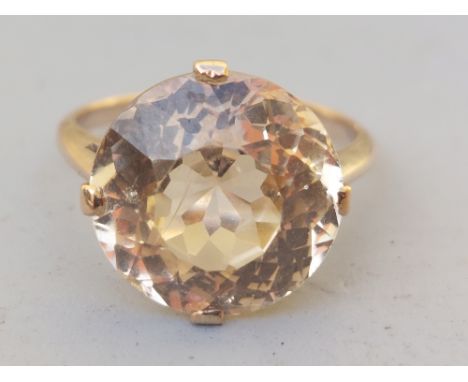 A certified natural light yellow Sri-Lankan sapphire solitaire ring, the four-claw set stone weighing approximately 9 carats 