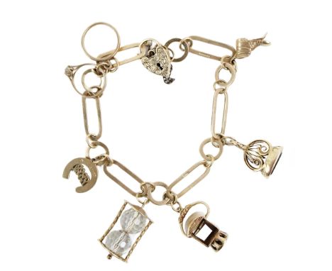 A 9ct gold long shaped link Charm Bracelet, with love heart shaped clasp, and 6 charms, including old boot, seal, horseshoe, 