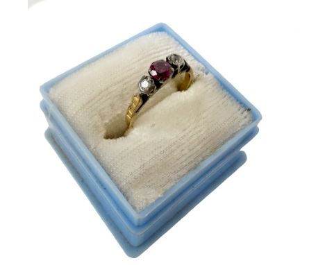 A gold Ladies Ring, with central ruby type stone flanked with diamonds either side, ring size approx. 'L', hallmarked. (1)