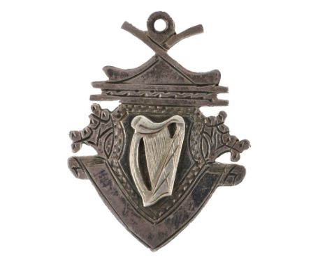 Medal: G.A.A., Hurling, (Co. Cork) 1964, a shield shaped silver Medal, the obverse with crossed hurls, harp overlay, the reve